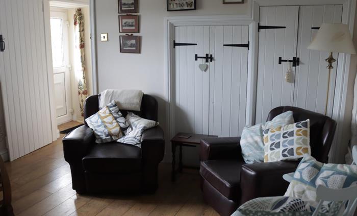 A cosy quiet room with log burner. two steps down to kitchen/diner, 3rd bedroom shower room and utility room. Rear entrance parking and ECP